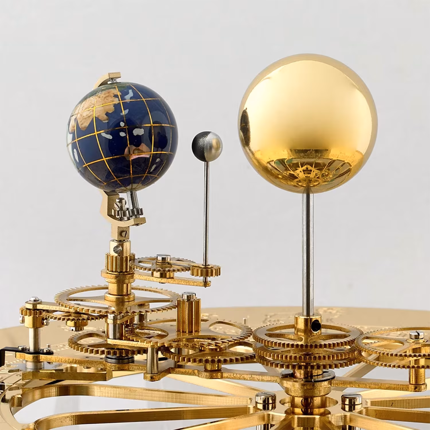 A detailed view of the Earth, Moon, and Sun mechanisms of the Hermle Tellurium 22823, featuring a delicate movement structure.